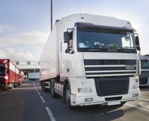 Driving at Work - Driver & Operator law & risks - Images shows Truck driver and his truck - waiting for a ferry
